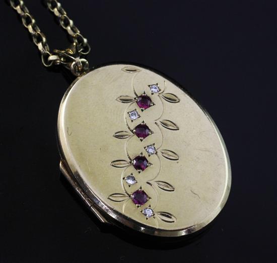 An early 20th century 9ct gold, ruby and diamond set oval locket, locket 1.5in.